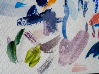 colored paint strokes on white paper