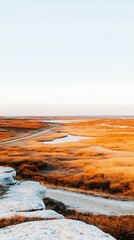 Serene Autumn Landscape Golden Grasslands Meet Calm Waters A picturesque view of a tranquil autumn scene