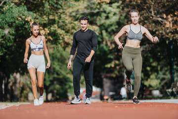 Fototapeta premium Three individuals engage in physical fitness activities outdoors in a park during daylight, enjoying an active and healthy lifestyle together on a sunny day.