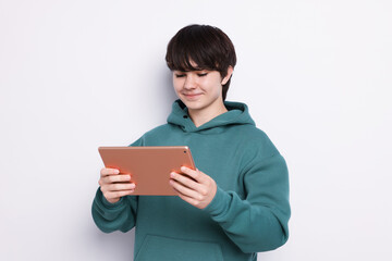 Teenage boy with tablet on white background