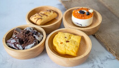 different cake or biscuit in different small wooden bowl 