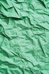 Fototapeta premium Textured green paper creates an interesting background for artistic projects or crafting