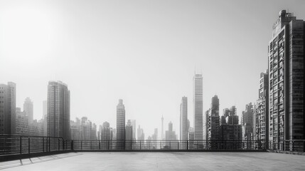 Empty rooftop vista of modern cityscape in grayscale.