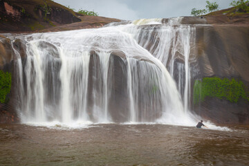 Obraz premium The grand beauty and fun water play and slides of Tham Phra Waterfall in the rainy season, Bueng Kan province Thailand 