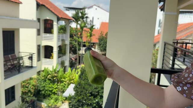 Green smoothie. Man drinking vegetable juice living healthy eating lifestyle. Closeup of green smoothie with spinach, kale etc.