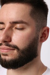 Obraz premium Man before eyebrows correction on light background, closeup