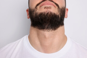 Man before shaving on light background, closeup