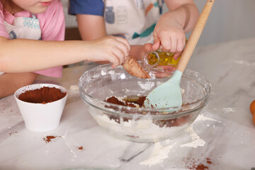Cooking recipe. Cute children making dough for cookies at table in kitchen, closeup