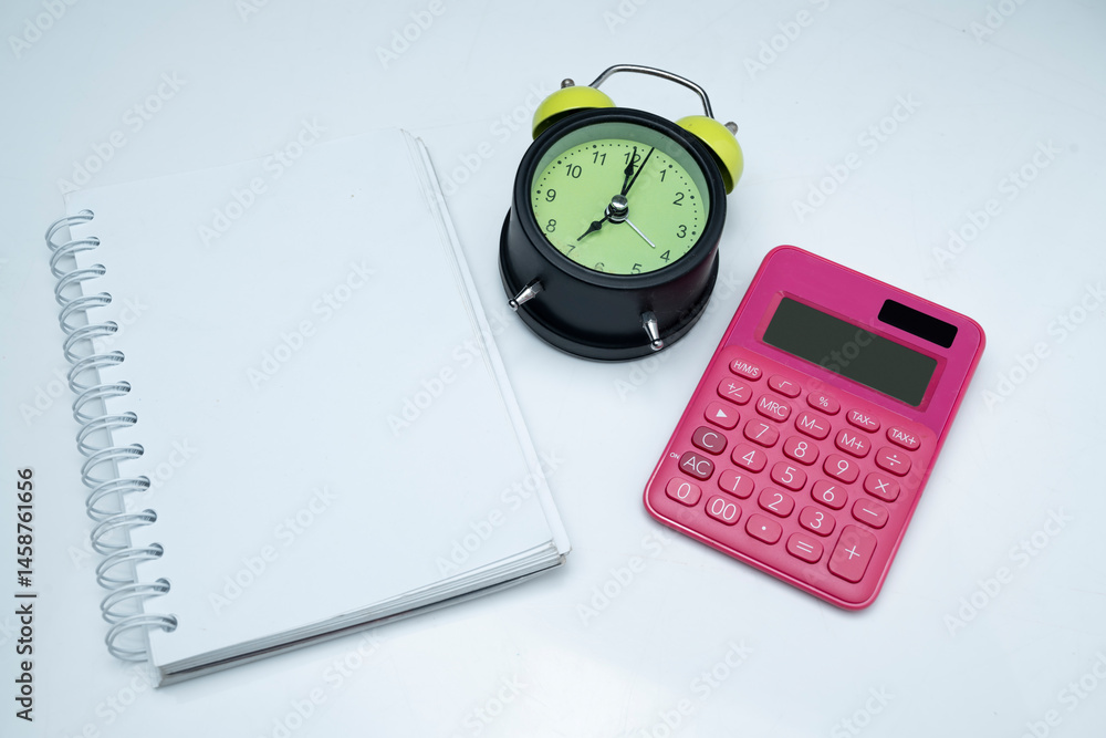 Poster green alarm clock and calculator with a notebook on a white background. empty area for mockup or cop