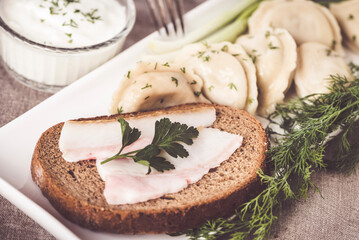 Ukrainian traditional serving of bread with lard and dumplings with potatoes
