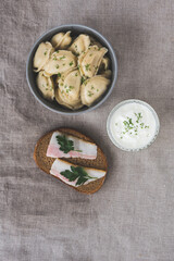 National Ukrainian snack with dumplings and a sandwich with bacon. Traditional Ukrainian dish. National cuisine. Flat design.
