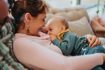 A tender moment of a mother bonding with her baby through breastfeeding, creating an intimate and...