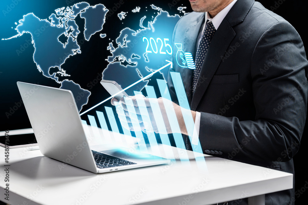 Aufkleber businessman using a cellphone and showing a world map and an upward chart in 2025 on the laptop scre