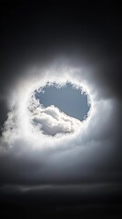 Dramatic sky hole in swirling clouds.