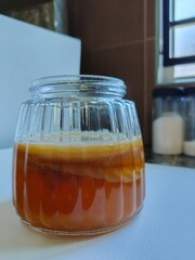 Kombucha tea drink in glass jar. SCOBY culture. Fermented foods, prebiotic, probiotic, healthy food concept. Wellness lifestyle.