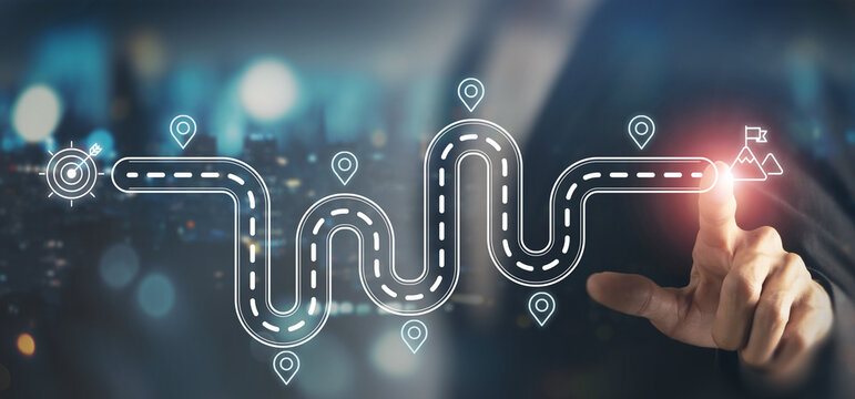 Business and Project Roadmap Concept. Touching on virtual screen with roadmap overlay representing steps in a project or strategic planning process. Waypoint icons and ends with goal achievement.