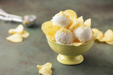 Sweet and salty vanilla ice cream balls and potato chips. Trendy american ice cream.