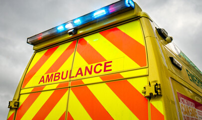 Ambulance lights - emergency services vehicle with flashing lights travelling to scene. Medically equipped transport rushes patients with paramedics to health care hospital facility for treatment.