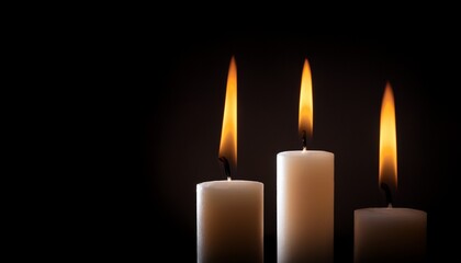 three candles burning in the dark available copy space
