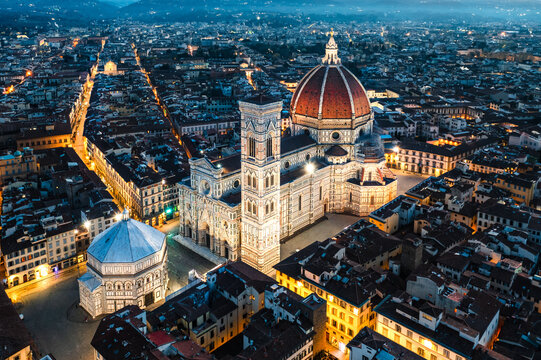 Aerial of the Duomo and square at night, Florence, Italy
