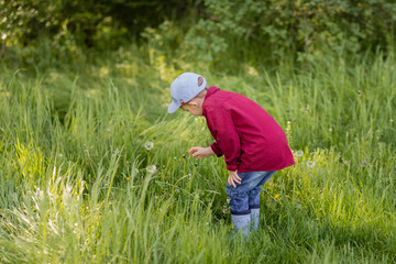 little boy playing in the grass