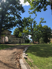 Weathered building and structures on the grounds of the ancient Malpils manor surrounded by lush green park. Malpils, Latvia. Historic venue for special events