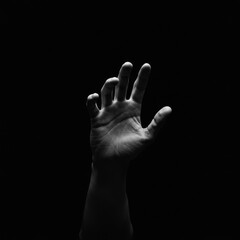 Grayscale Hand Reaching in Darkness