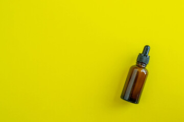 Bottle for cosmetics on a yellow background. Beauty saloon. Background with copy space