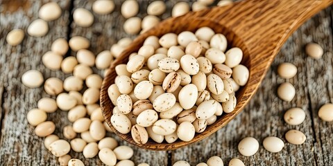 Fototapeta premium Rustic Wooden Spoon and Dried White Beans
