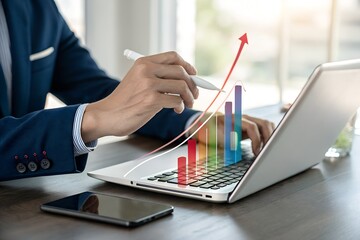 Businessman analyzing financial data and business growth with bar graphs on a laptop in office setting