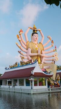 Giant statue of Guanyin, the Goddess of Mercy and Compassion in East Asian Buddhism with eighteen arms in Wat Plai Laem temple surrounded by water lake on Koh Samui island in Thailand