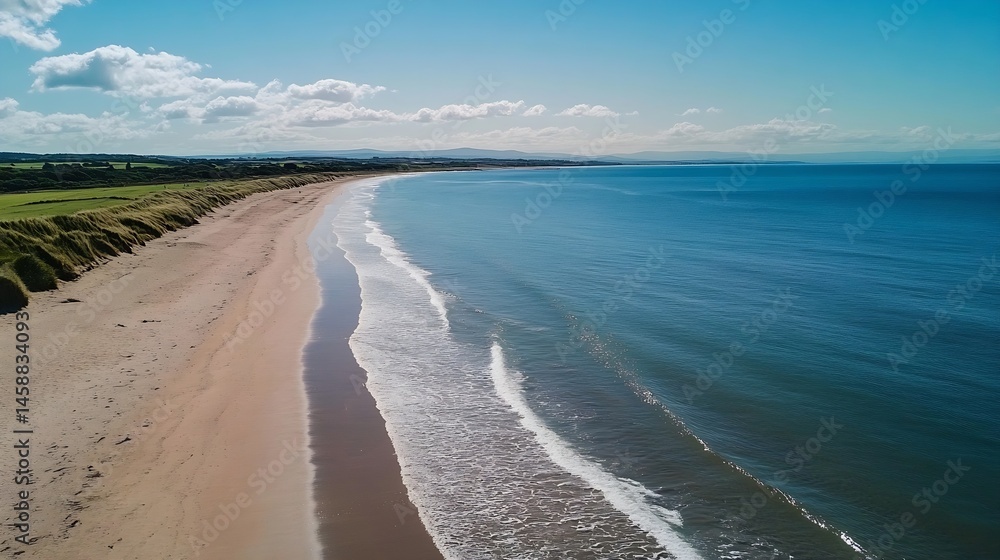 Poster aerial view of a pristine sandy beach meeting a tranquil turquoise ocean under a partly cloudy sky, 