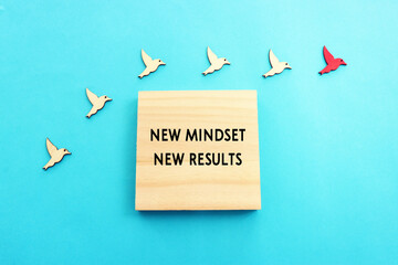 Concept image of group of birds following the leader and wooden board with text