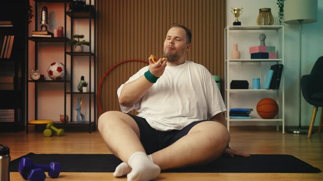 Large-bodied man enjoying pizza instead of training, cheat meal celebration