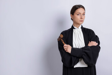 Judge with mallet on light background, space for text