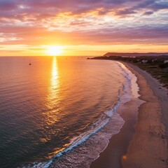 Vibrant Sunset Over Sandy Beach and Calm Ocean