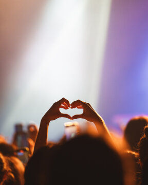 Silhouette of Hands Forming a Heart Shape at a Concert
