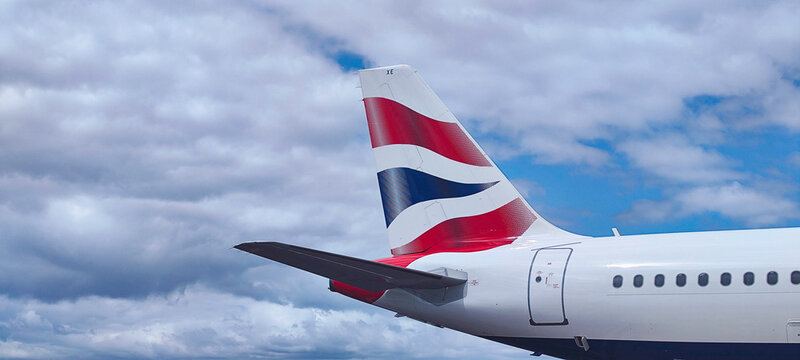 British airways airplane tail standing out against cloudy sky background