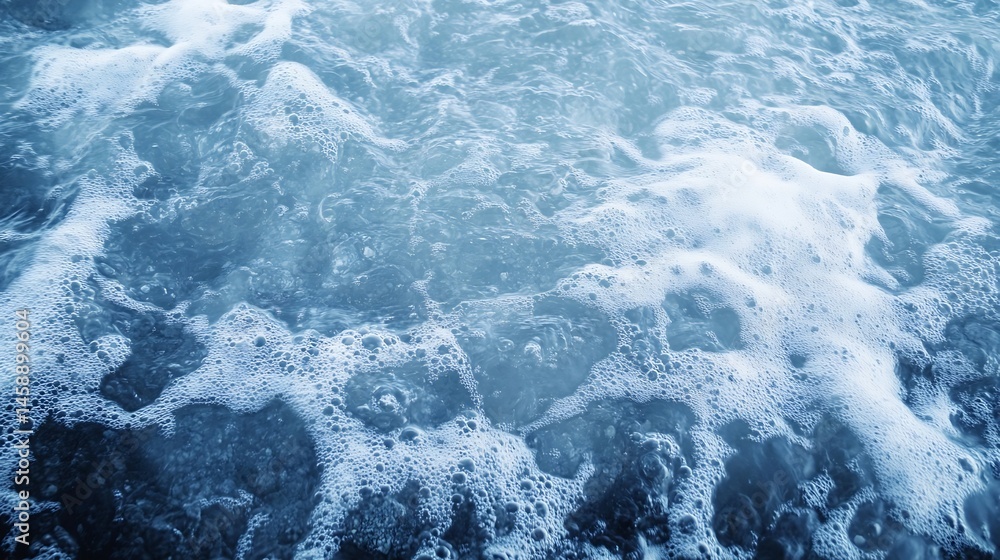 Fototapete Close-up view of ocean water with white foam and bubbles, creating a textured surface with shades of blue and grey.  The image evokes a sense of calmness and serenity. : Generative AI