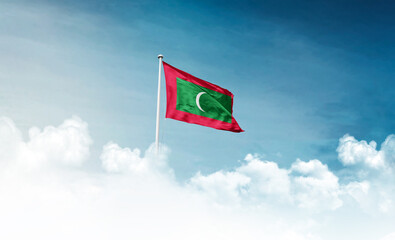 Maldives national flag with mast waving in beautiful sky. Maldives flag for Republic Day and...