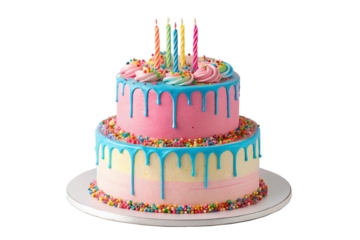 Festive two tiered birthday cake with colorful frosting sprinkles and lit candles against a black