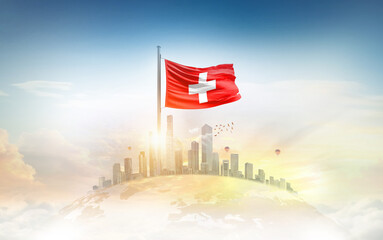 Switzerland flag wavering on globe with modern building skyline. Flag waving on world map. Switzerland national flag for independence day.