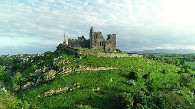 Aerial view of historic church ruins in a green landscape with blue sky