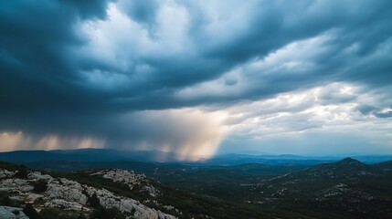 Dramatic rain shower over a mountainous landscape, showcasing dark clouds and sunbeams breaking through, creating a breathtaking vista. : Generative AI