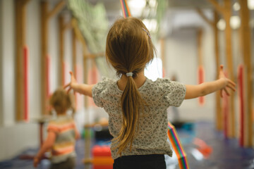 girl playing happily in a kindergarten or amusement playground