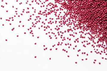 Scattered red seeds on white background (1)