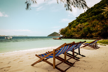 Coral Beach, Thailand - February 27, 2025: Beach chairs and scenery on Coral Beach on Coral Island in Thailand
