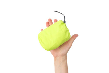 Bright neon windbreaker folded into green pouch in hand, compact and portable design for outdoor product showcase, perfect for travel gear, hiking clothing or sports accessory branding, © Elena