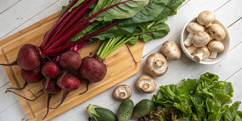 Overhead image of fresh produce, including beetroot and mushrooms