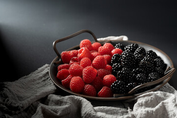 Freshly picked raspberries and blackberries, beautifully arranged for a naturally sweet delight